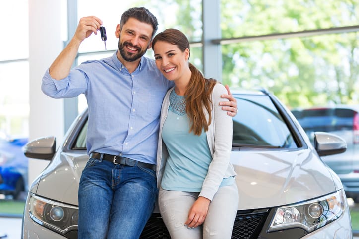 Young couple buying a car