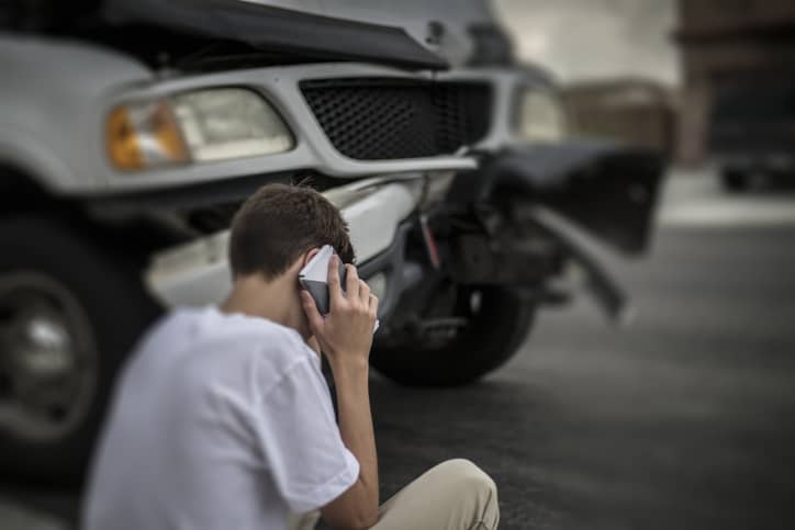 Man on phone at car accident